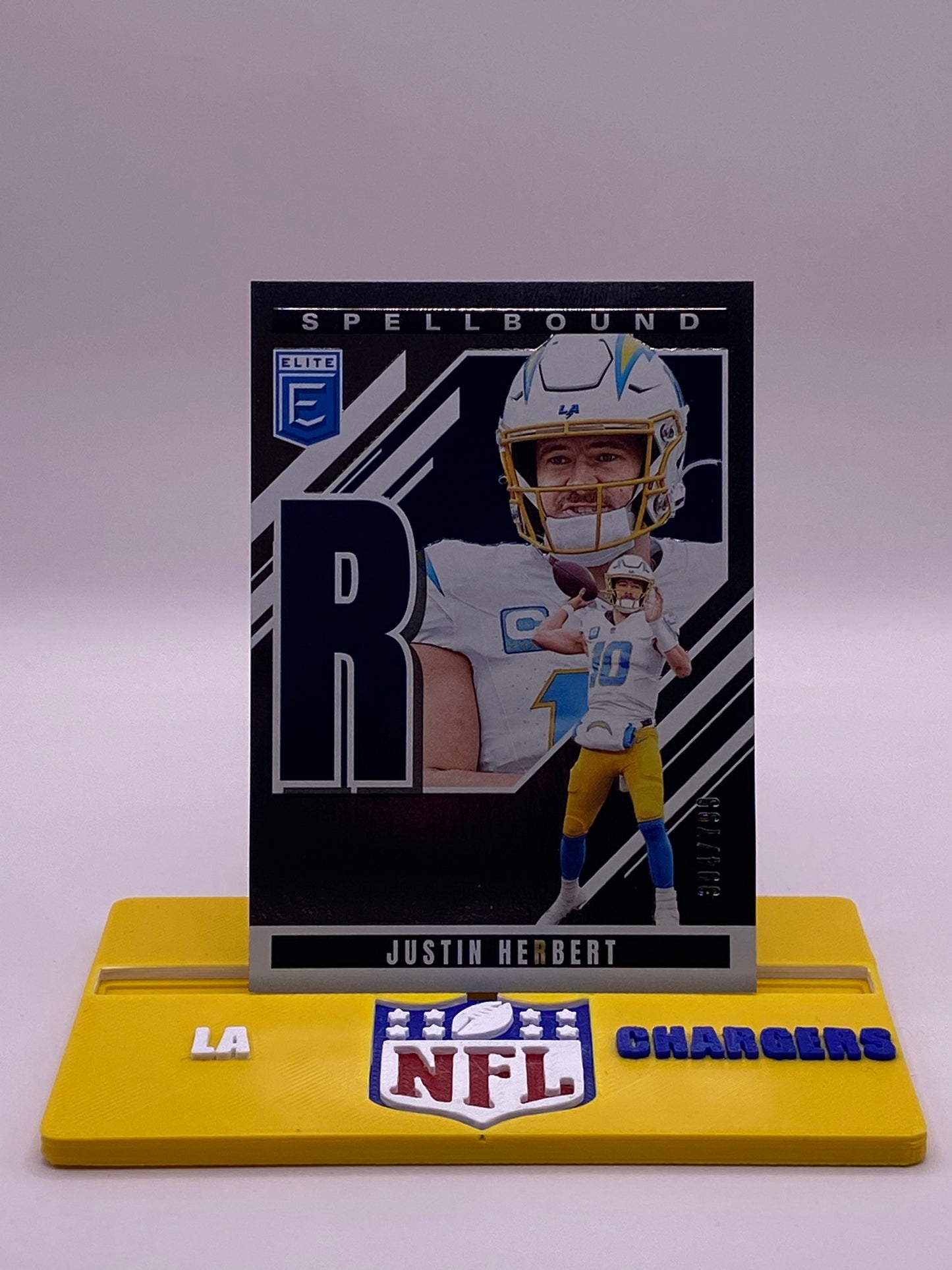 2025 Panini Donruss Elite Spellbound Justin Herbert “R” /799 (394/799) – LA Chargers #36