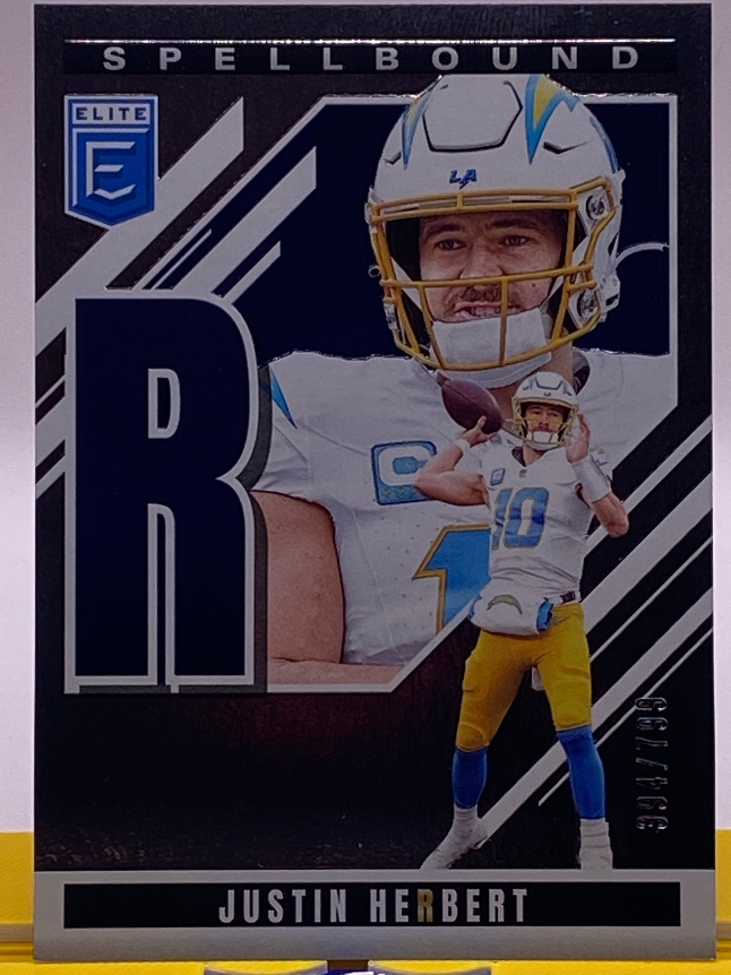 2025 Panini Donruss Elite Spellbound Justin Herbert “R” /799 (394/799) – LA Chargers #36
